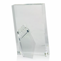 The Tizo Lucite Clear Frame is a minimalist, rectangular acrylic picture frame with a transparent support stand, allowing it to stand upright on flat surfaces. The empty frame is displayed against a white background.
