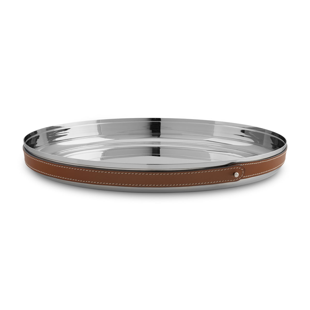 The Nambe Tahoe Bar Tray is a round, shiny stainless steel tray with a brown leather-wrapped rim, visible white stitching, and a metal stud accent, shown on a white background.