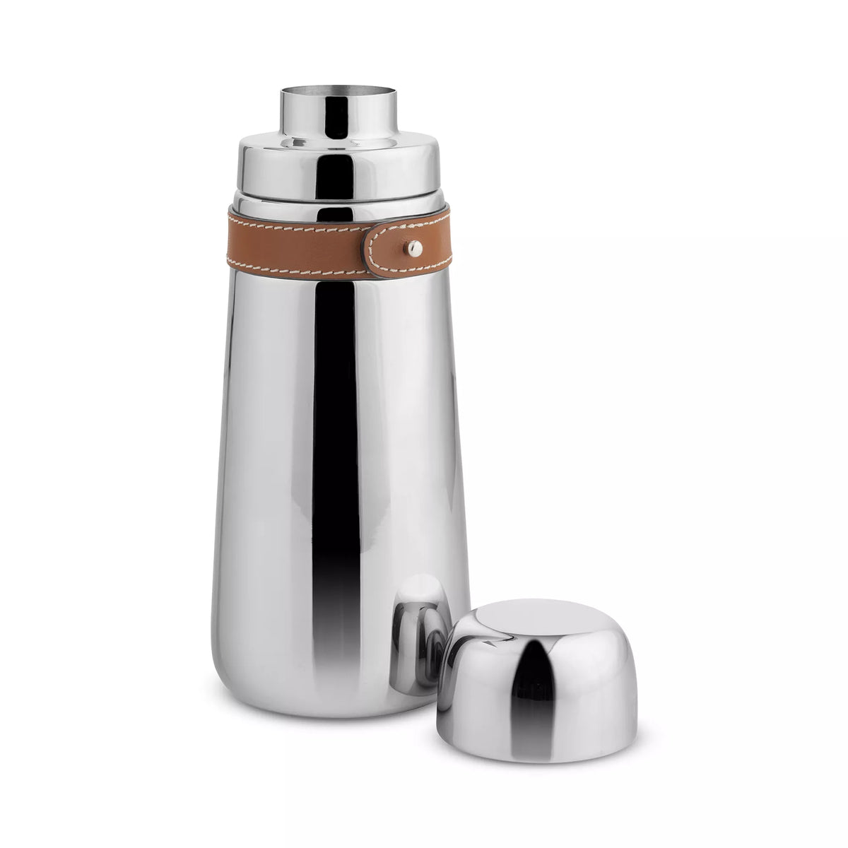 The Nambe Tahoe Cocktail Shaker is a polished stainless steel barware piece with an elegant brown leather accent near the top, shown upright with its cap off and placed beside it.