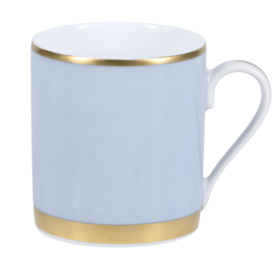 The Recamier Grey & Gold Dinnerware mug by Royal Limoges features light blue porcelain with gold rims, a smooth finish, and a curved handle on the right side.