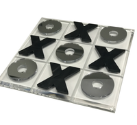 Eye Candy’s Marble & Silver Acrylic Tic Tac Toe Set features a clear acrylic 3x3 board with shiny silver O pieces and black marble X pieces, creating a modern, stylish game that enhances any space.