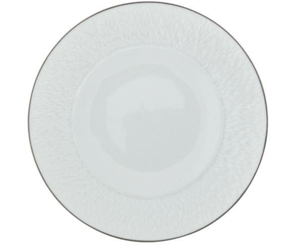 A round, white Limoges porcelain plate from Raynaud's Mineral Irise Dinnerware Platinum collection features a subtle textured rim and platinum detailing, viewed from above against a white background—an elegant dinnerware piece.