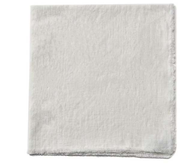 The Deborah Rhodes Woven Washed Fringe Napkin Natural Set of 4 features square, off-white linen cotton napkins with a textured surface and fringed edges, shown neatly folded on a white background.