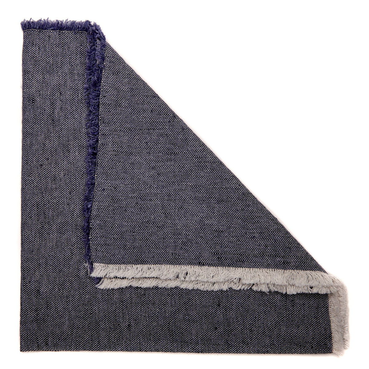 Folded navy napkin with frayed edges and woven texture, reminiscent of dark denim, from the Woven Washed Fringe Napkin Navy Set of 4 by Deborah Rhodes.