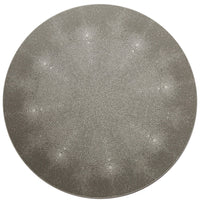The Shagreen Placemat by Tisch New York features a round, flat, gray design with a subtle textured pattern of small interconnected dots and faint radiating lines that create a starburst effect from the center.
