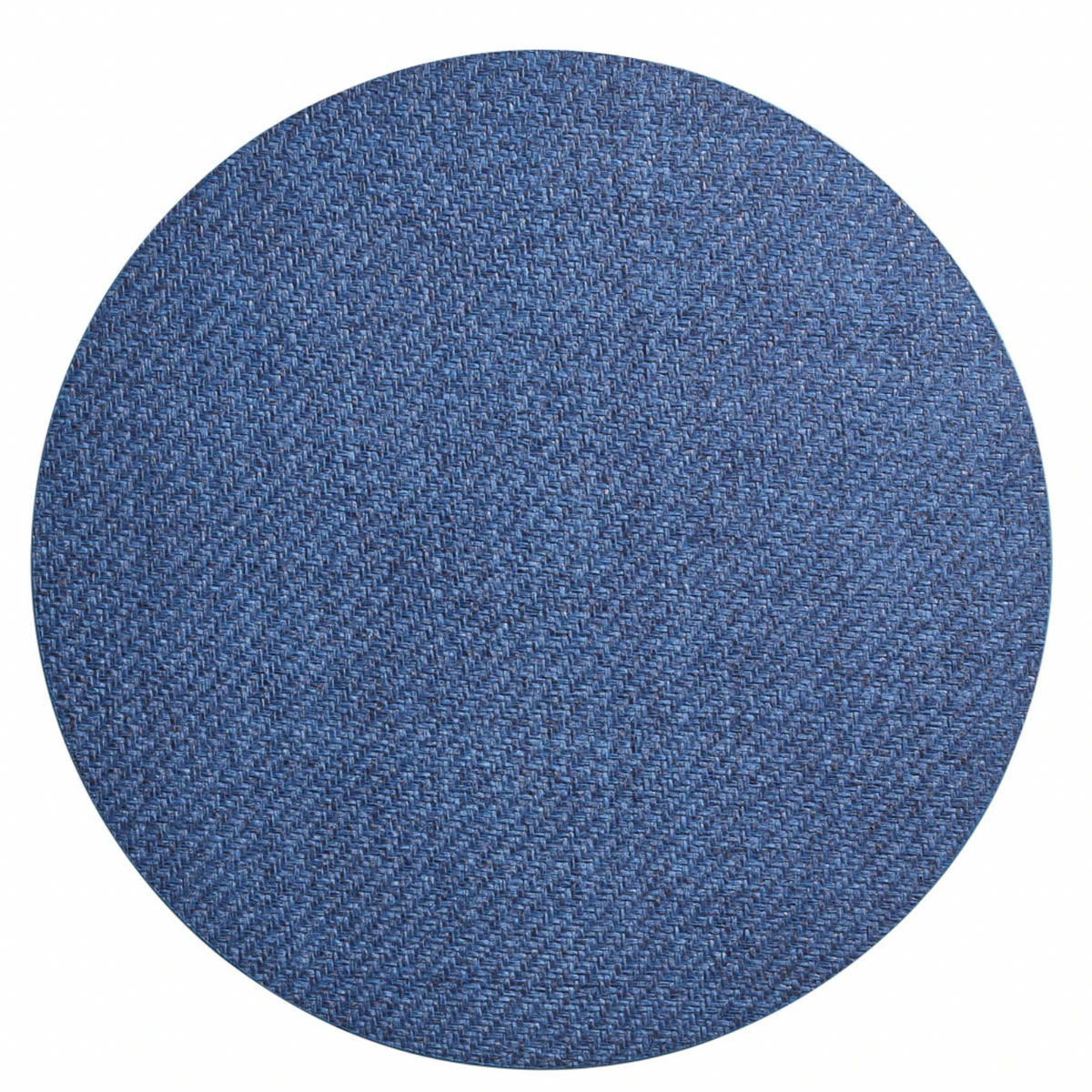 The Saigon Placemat Navy Set of 4 by Kim Seybert features circular blue denim placemats with a visible woven texture, inspired by Vietnamese plaiting technique, shown from above on a white background.