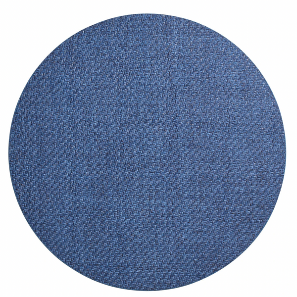 The Saigon Placemat Navy Set of 4 by Kim Seybert features circular blue denim placemats with a visible woven texture, inspired by Vietnamese plaiting technique, shown from above on a white background.