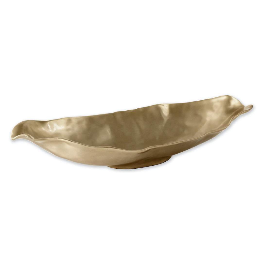 The Beatriz Ball Sierra Maia Long Oval Medium Bowl is an eco-friendly, gold-colored ceramic piece with uneven, wavy edges and a leaf-like shape, displayed on a plain white background for an elegant look.