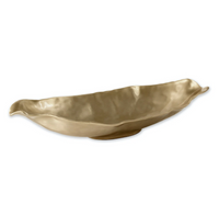 The Beatriz Ball Sierra Maia Long Oval Medium Bowl is an eco-friendly, gold-colored ceramic piece with uneven, wavy edges and a leaf-like shape, displayed on a plain white background for an elegant look.
