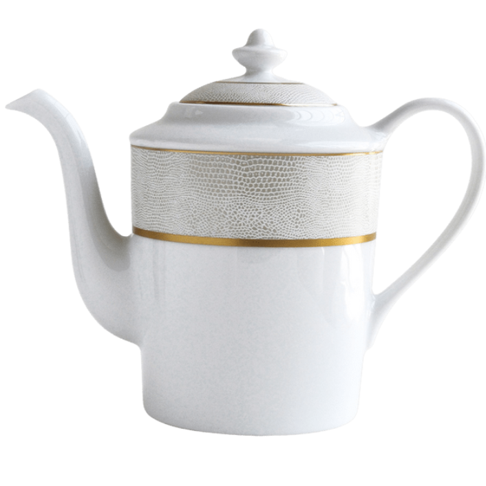 The Bernardaud Sauvage Gold teapot features white porcelain, a curved spout, large handle, lid, embossed snake skin gray band, and gold accent near the top for an elegant Limoges-inspired look.