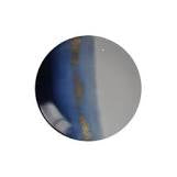 A round, reflective surface with a blue and gray gradient and brownish streaks, possibly a close-up of Marie Daâge Horizon Gold Dinnerware by Marie Daâge.