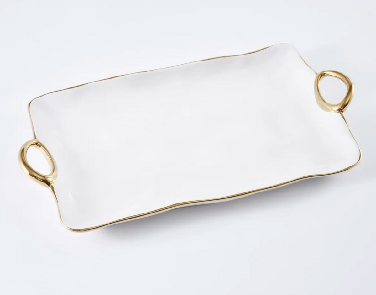 The PAMPA BAY Gold Handle Tray Large is a rectangular white porcelain tray with two gold handles and a gold-trimmed edge; dishwasher safe and oven safe for versatile use.