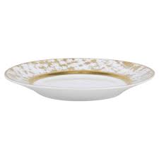 The Tweed White & Gold Dinnerware by Royal Limoges features a white ceramic plate with a wide, slightly raised rim adorned with a gold-speckled pattern and a smooth, plain center, reflecting the refined elegance of French design.