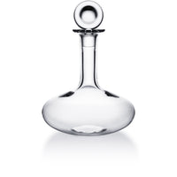 The Baccarat Oenologie Decanter by Baccarat, with its clear crystal design, round stopper, wide base, and narrow neck, is displayed against a plain white background.