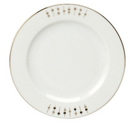 The Carrousel Dinnerware by Philippe Deshoulieres is a white Limoges porcelain plate with a thin gold rim and a minimalist border of gold lines and small squares, mainly decorating one side of the edge.