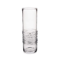 The Echo Lake Gather Vase by Simon Pearce is a tall, handmade glass vase with a smooth top and ribbed lower section. This clear, cylindrical vase is empty and shown against a white background.