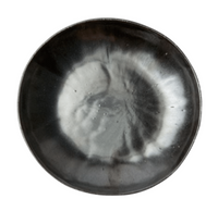 The Marcus Black Dinnerware Set of 4 by Blue Pheasant features round, shallow ceramic bowls with a glossy dark gray and black glaze and a unique cloudy white center pattern—an elegant, organic stoneware highlight for your table.