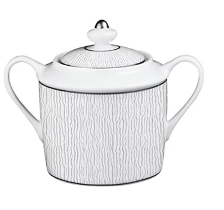 The Bernardaud Dune Dinnerware sugar bowl features two handles, a round-knob lid, and a subtle wavy textured pattern—an elegant white porcelain piece inspired by classic Limoges porcelain.