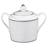 The Bernardaud Dune Dinnerware sugar bowl features two handles, a round-knob lid, and a subtle wavy textured pattern—an elegant white porcelain piece inspired by classic Limoges porcelain.