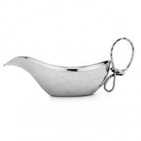 The Mary Jurek Opus Gravy Boat is a shiny handcrafted stainless steel piece with a curved spout, rounded body, and large looped handle, set against a plain white background.