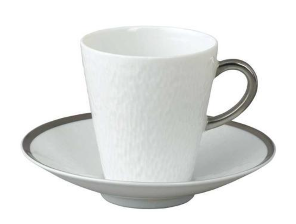 A Mineral Irise Dinnerware Platinum coffee cup by Raynaud, featuring a white ceramic body and metallic handle, sits on a matching saucer with a silver rim, highlighting its elegance against a plain white background.