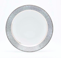The Makassar Gray & Platinum Dinnerware by Royal Limoges/Bia Cordon Bleu features a round white plate with a platinum, pebble-like textured rim and smooth center, handcrafted in France from fine Limoges porcelain. Background is white.