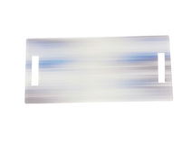 Eye Candy’s Serving Long Board | Blurred Lines is a semi-transparent acrylic platter with rectangular cut-out handles and light blue and white horizontal streaks—perfect for your kitchen island.