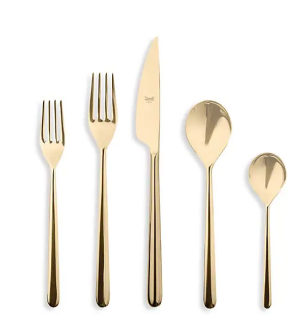 The Mepra Linea 5 Piece Setting - Oro features Italian stainless steel flatware with a gold finish, including a salad fork, dinner fork, dinner knife, soup spoon, and teaspoon, displayed side by side on a white background.