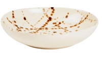 The Delaney Bronze Splatter Dinnerware by Blue Pheasant features a shallow, cream ceramic bowl with bronze splatter and brown swirl accents—an elegant handmade stoneware piece to elevate any collection.