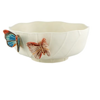 The Cloudy Butterflies Serving Bowl by Vista Alegre is a handcrafted white earthenware bowl with a scalloped edge, adorned with two 3D butterflies—one blue, one red—for a whimsical accent.