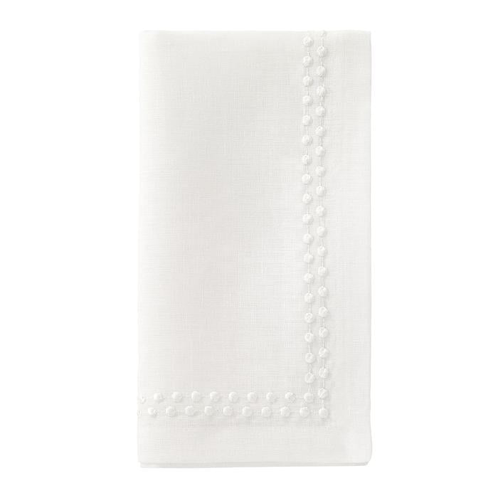 The Bodrum Pearls Napkin White Set of 4 features finely folded linen napkins with embroidered edges and small decorative dots along two sides, shown on a plain white background.