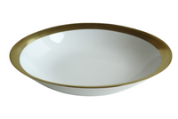 The Royal Limoges Danielle Gold Dinnerware features a white porcelain bowl accented with a shiny gold band, shown against a white background.