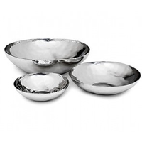 The Luna Serving Bowl 8" by Mary Jurek is a shiny, stainless steel bowl with a smooth, slightly hammered texture and rounded edges. Dishwasher safe for easy cleaning, it combines elegance with practicality.