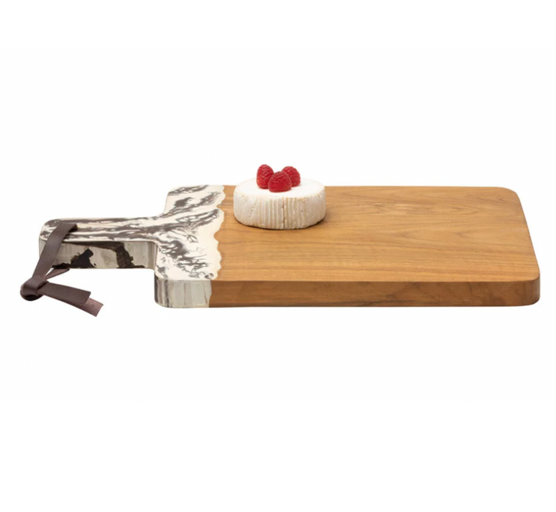 The Austin Swirled Cheeseboard by Blue Pheasant features a marbled grey and white handle, perfect for serving a small wheel of cheese topped with raspberries.