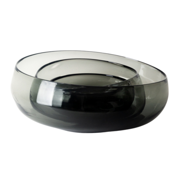 The Gary Bodker Nesting Glass Bowl Charcoal features hand-blown, dark gray glass with smooth, rounded edges and an asymmetrical form, showcasing modern elegance against a white background.