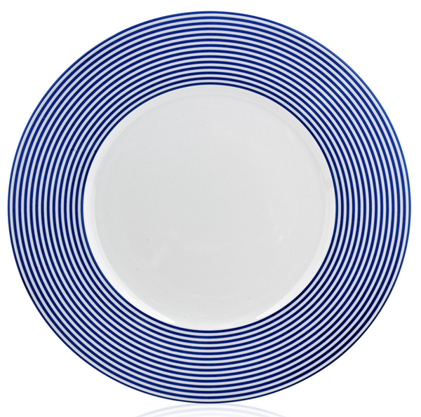 The Latitudes Dinnerware by Royal Limoges features a round white plate with a wide rim adorned with evenly spaced concentric blue stripes, creating a modern look. Crafted from fine Limoges porcelain, the center remains plain white.