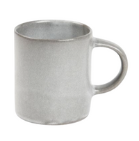 The Marcus Cement Dinnerware Set of 4 by Blue Pheasant features plain gray ceramic pieces with smooth surfaces and rounded handles—perfect for pairing with your favorite dishwasher-safe mugs, all shown against a white background.