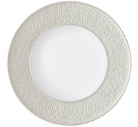 The Raynaud Mineral Irise Dinnerware Pearl Grey is a round, white Limoges porcelain plate with a smooth center and a wide, subtly wavy textured light gray rim.