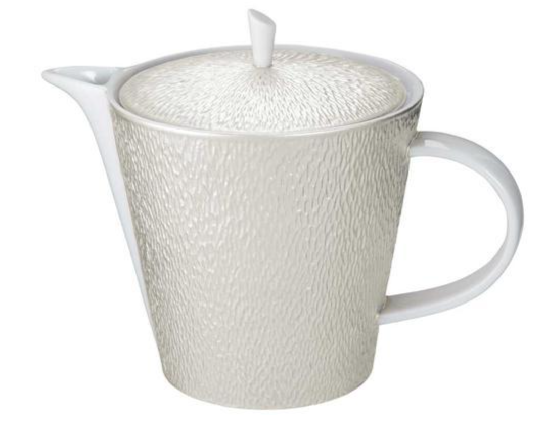 The Raynaud Mineral Irise Dinnerware Pearl Grey teapot features a textured, pearl grey ceramic body with a round lid, short spout, and large curved handle. Its subtle raised pattern evokes classic French Limoges porcelain.