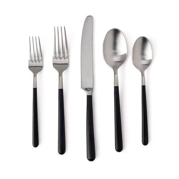 The Simon Pearce Hampton Flatware 5 Piece Setting includes two forks, a knife, a tablespoon, and a teaspoon with black resin handles and stainless steel, shown side by side on a white background.