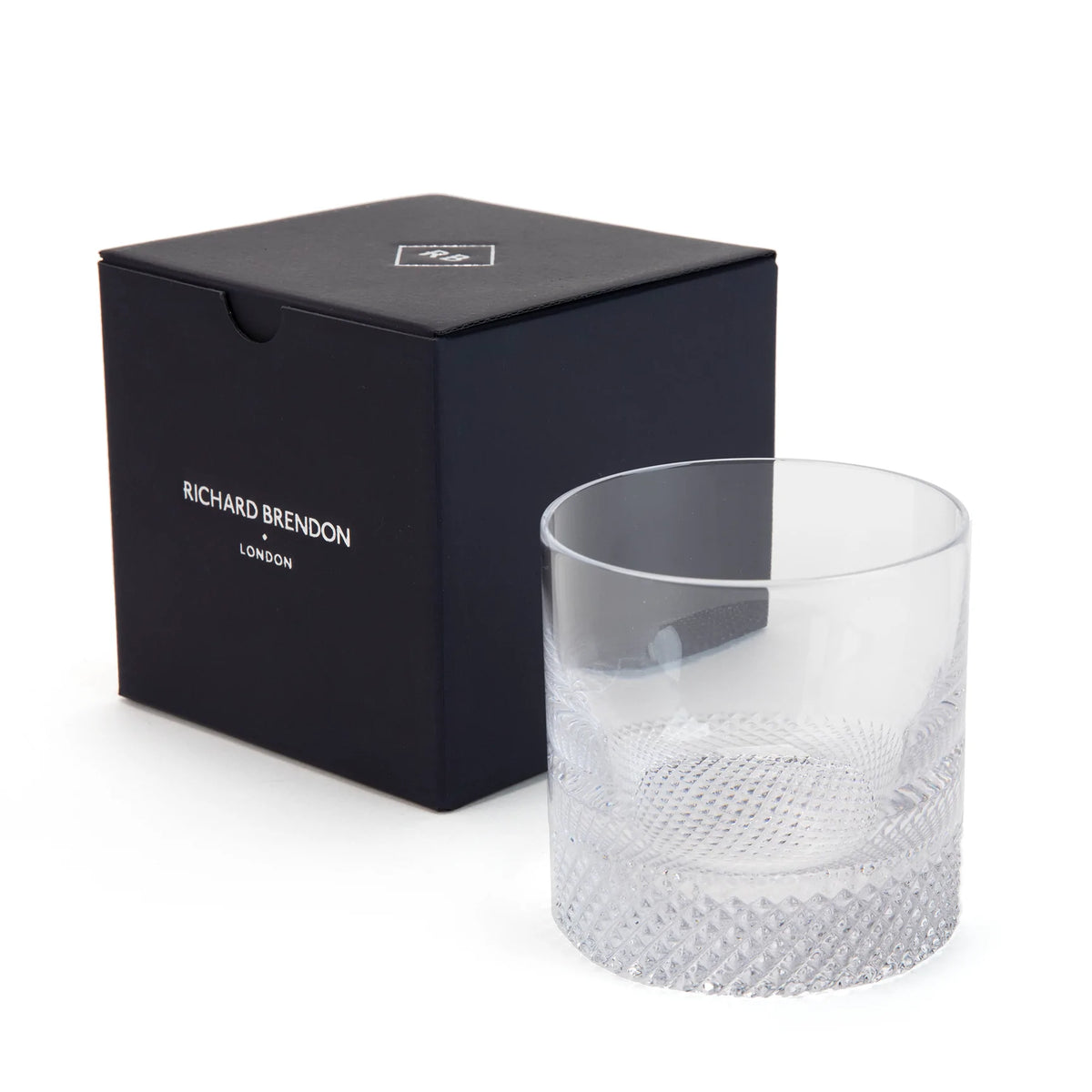 The Diamond DOF Old Fashioned glass by Richard Brendon sits beside its signature navy blue gift box.