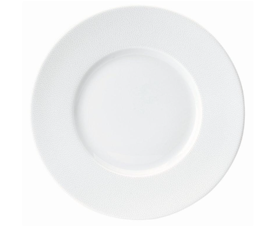 The Seychelles Dinnerware by Philippe Deshoulieres features a plain white, round porcelain plate with a subtly textured rim, displayed from above against a white background.