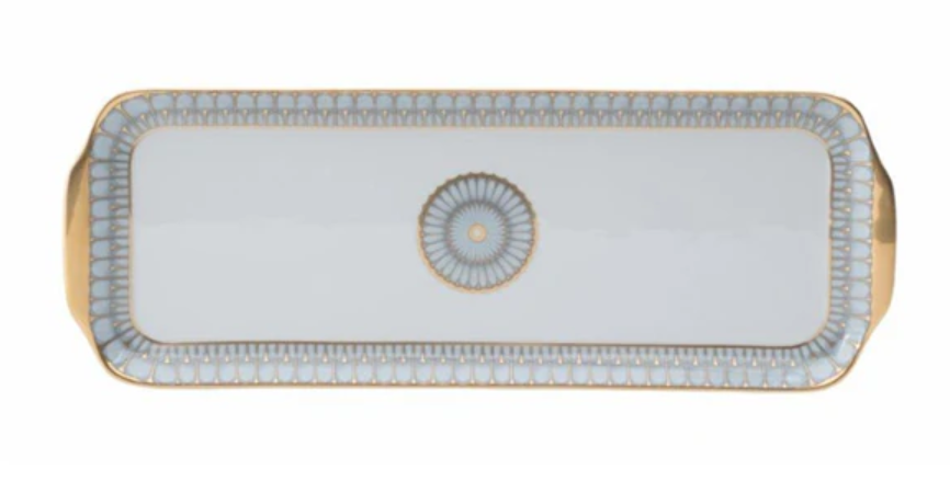 A rectangular platter from the Philippe Deshoulieres Arcades Gold Dinnerware collection features gold handles, a blue and gold border, and a central blue and gold motif on white Limoges porcelain.