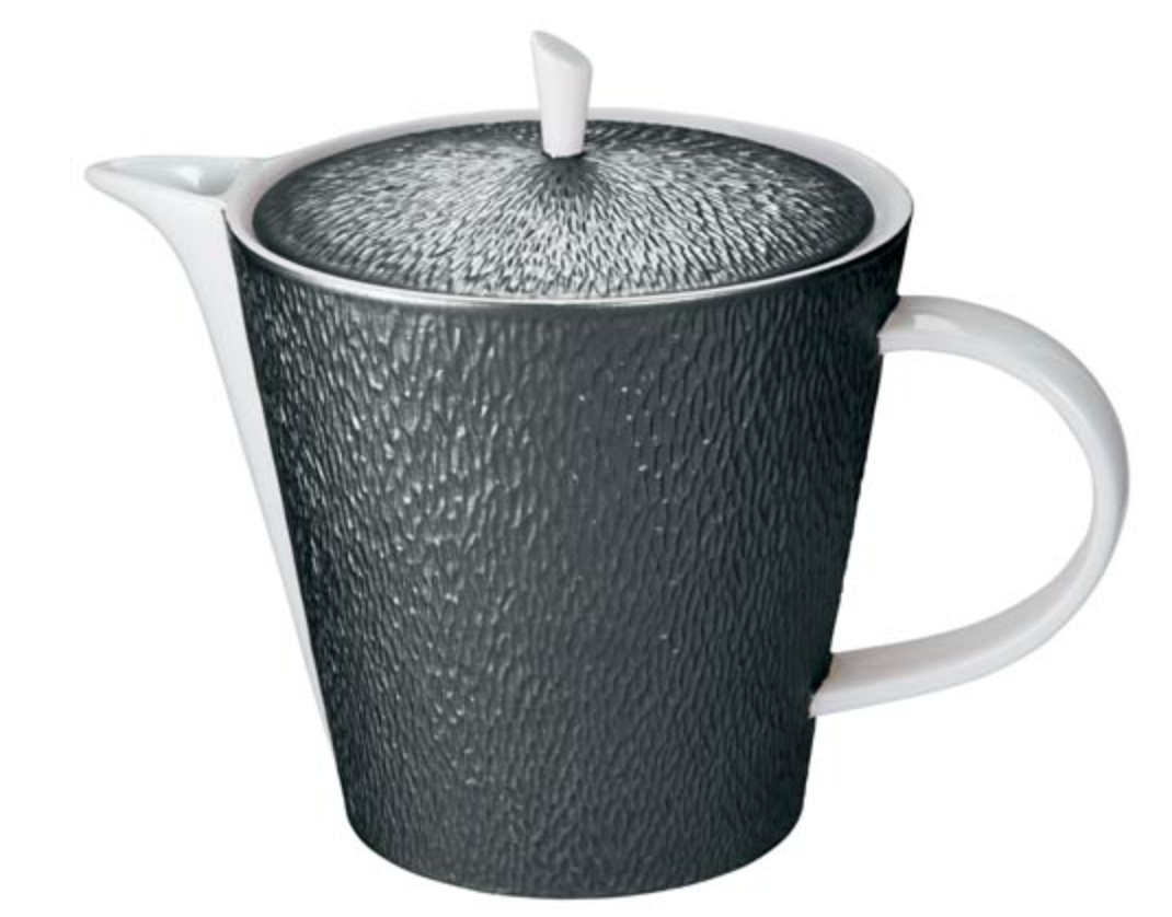 The Raynaud Mineral Irise Dinnerware - Black features a ceramic teapot with a textured dark gray body, white handle, spout, and lid with a white knob—a stylish accent for modern collections.