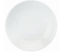 The Seychelles Dinnerware by Philippe Deshoulieres features a plain, round white ceramic plate with a slightly raised rim and smooth surface, evoking the timeless elegance of classic Limoges porcelain.