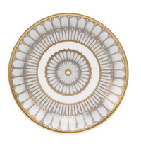 The Philippe Deshoulieres Arcades Gold Dinnerware white plate features an intricate gold and gray geometric pattern with scalloped and circular designs, and is finished with a gold rim.