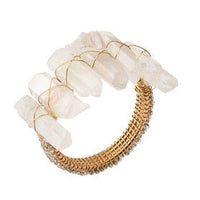 The Radiant Napkin Ring Iridescent Set of 4 by Kim Seybert features large, raw white crystals atop a gold ring, artfully wrapped with thin gold wire for a look reminiscent of elegant crystal jewelry.