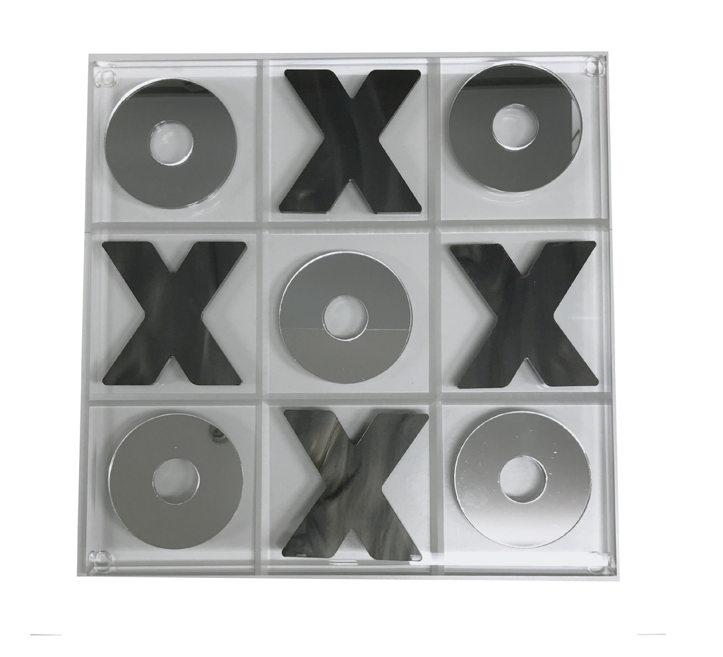 The Eye Candy Marble & Silver Acrylic Tic Tac Toe Set features a clear acrylic board with mirrored marble X and O pieces; Xs fill the top center, middle left, middle right, and bottom center squares, while Os take the other spots.