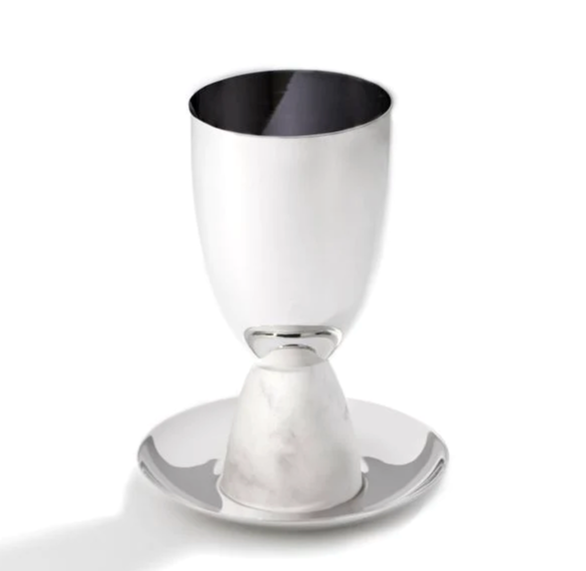 The Coluna Marble Kiddush Cup Silver by Anna New York stands upside down on a sleek white saucer. It features a shiny finish and an Italian Carrara marble-textured base, set against a clean white background.