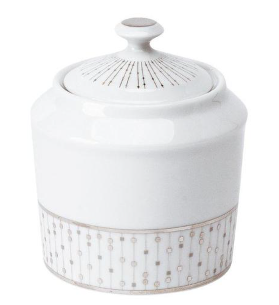 A white Limoges porcelain sugar bowl with lid from the Philippe Deshoulieres Carrousel Dinnerware, featuring geometric gold and silver patterns along the base and lid.